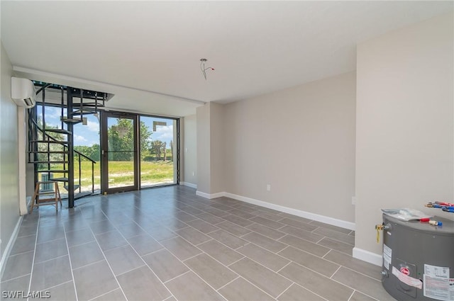 unfurnished room featuring electric water heater, a wall of windows, and an AC wall unit