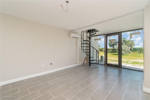 empty room with plenty of natural light, expansive windows, and a wall unit AC