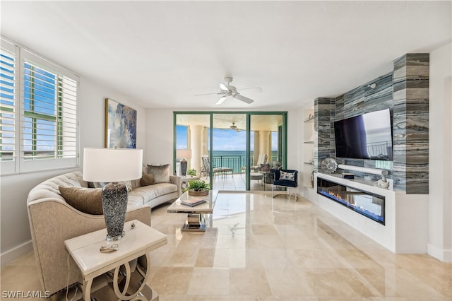 tiled living room with ceiling fan and a large fireplace