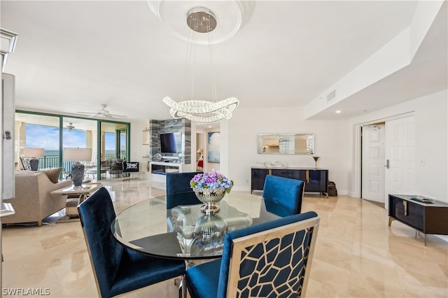 dining room with floor to ceiling windows, ceiling fan, and light tile flooring