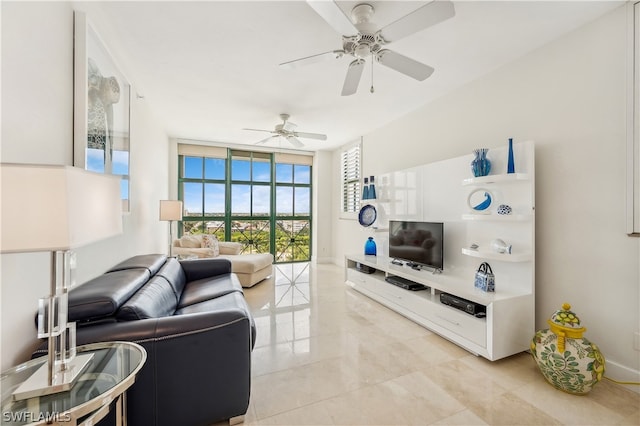 living room with ceiling fan, a wall of windows, and light tile flooring