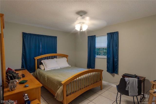 tiled bedroom with a textured ceiling and ceiling fan