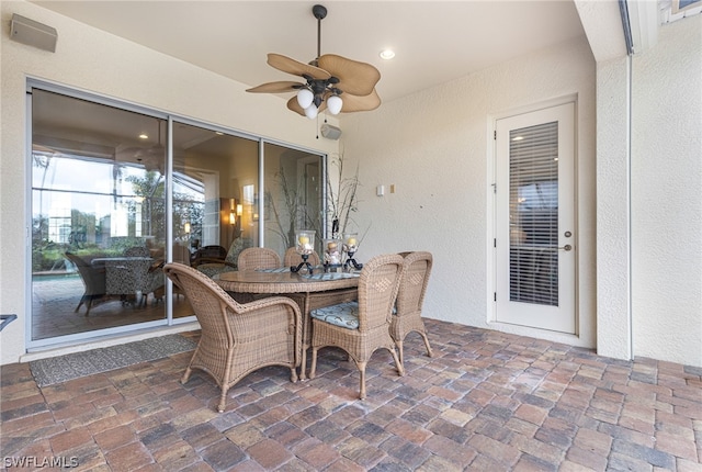 sunroom featuring ceiling fan