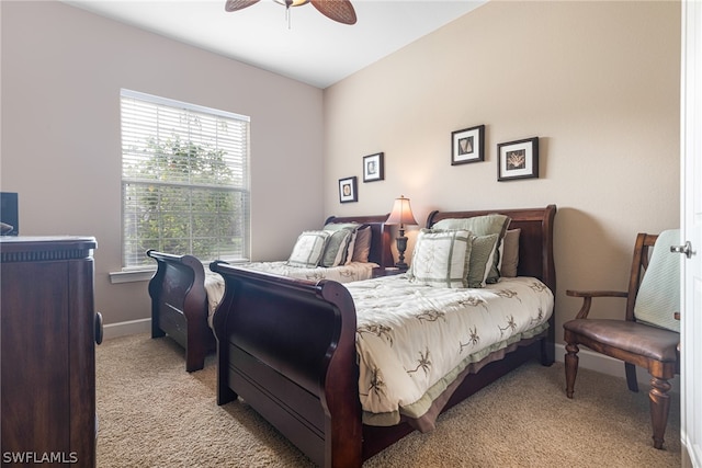 carpeted bedroom with ceiling fan and multiple windows