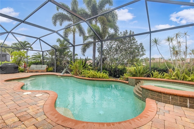 view of swimming pool with an in ground hot tub, a lanai, area for grilling, a patio area, and an outdoor hangout area