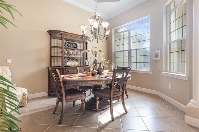 dining space featuring tile patterned floors, crown molding, plenty of natural light, and an inviting chandelier