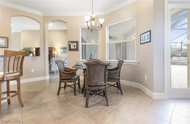 tiled dining space featuring a wealth of natural light, crown molding, and an inviting chandelier