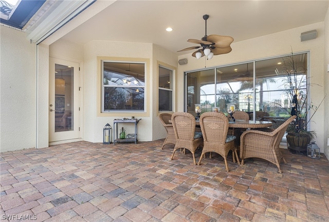 view of patio / terrace with ceiling fan and glass enclosure