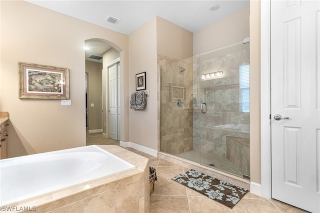 bathroom with separate shower and tub, tile patterned flooring, and vanity