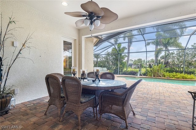 sunroom featuring ceiling fan and a healthy amount of sunlight