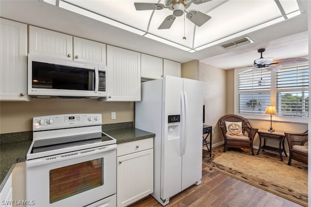 kitchen with dark hardwood / wood-style floors, white appliances, ceiling fan, and white cabinetry