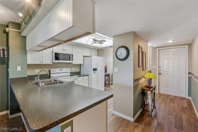 kitchen featuring white appliances, ceiling fan, dark hardwood / wood-style floors, white cabinets, and sink