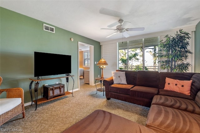 carpeted living room featuring ceiling fan