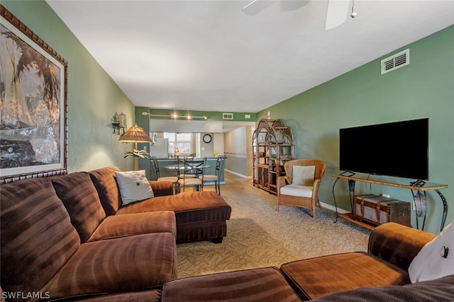 carpeted living room with ceiling fan