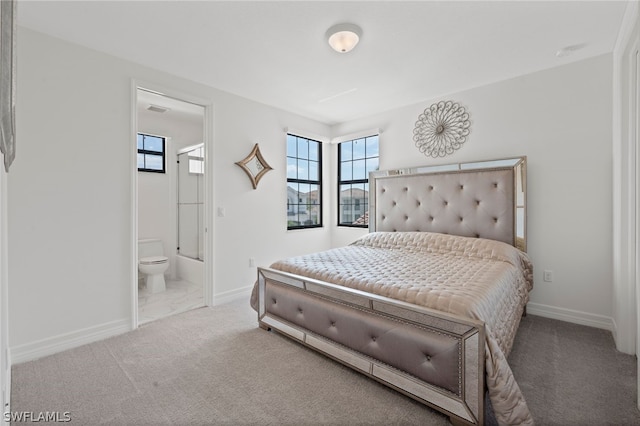 carpeted bedroom featuring connected bathroom