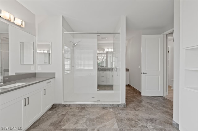 bathroom featuring tiled shower and vanity