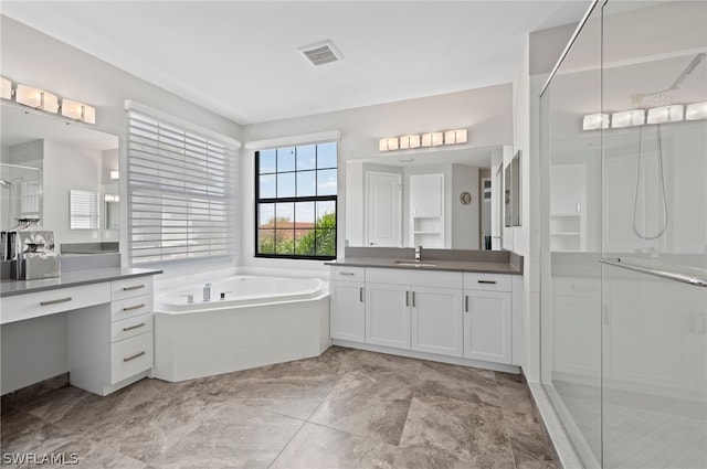 bathroom featuring tile patterned flooring, vanity, and independent shower and bath