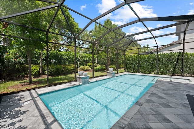 view of swimming pool featuring glass enclosure and a patio area