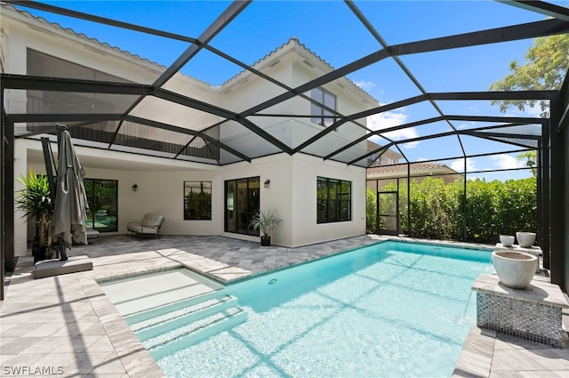 view of swimming pool with a lanai and a patio area