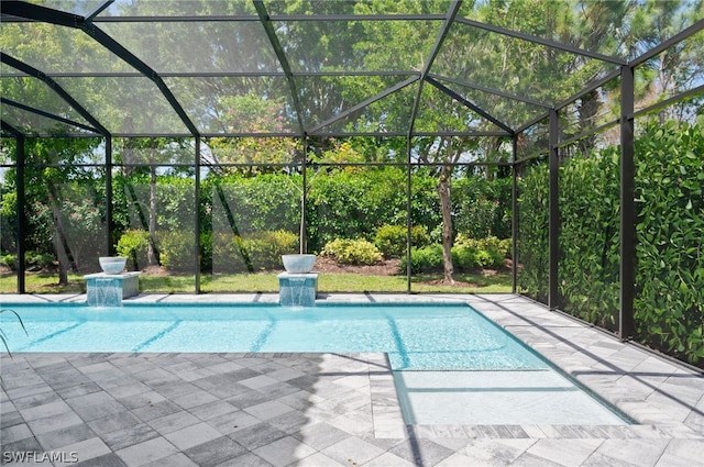 view of pool with pool water feature, a patio area, and a lanai