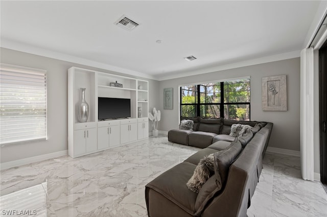 living room with built in shelves and crown molding