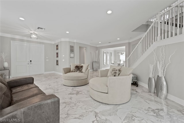 living room featuring crown molding and an inviting chandelier