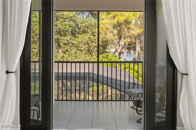 doorway to outside featuring tile patterned flooring and a wealth of natural light