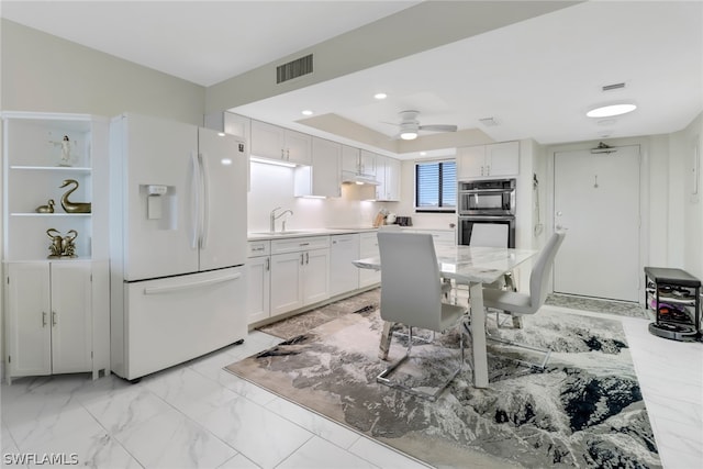 kitchen featuring sink, white cabinetry, white appliances, and ceiling fan