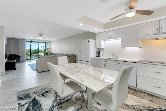 dining room featuring ceiling fan and sink