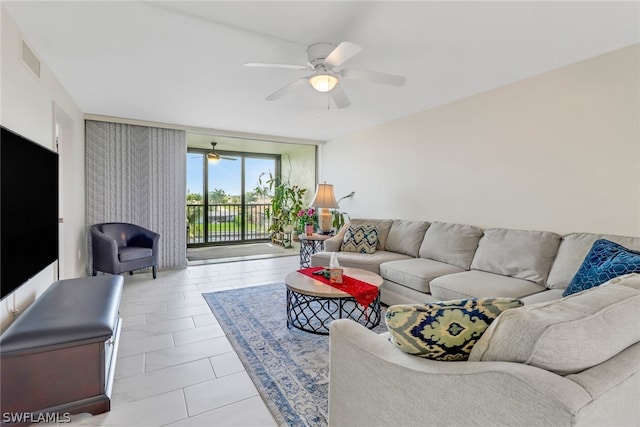 tiled living room with ceiling fan