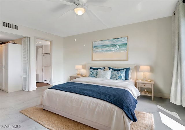 bedroom with ceiling fan and ensuite bath