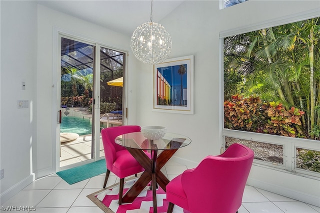 dining space with a healthy amount of sunlight, light tile flooring, and a chandelier