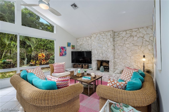 living room featuring a fireplace, high vaulted ceiling, ceiling fan, and tile floors