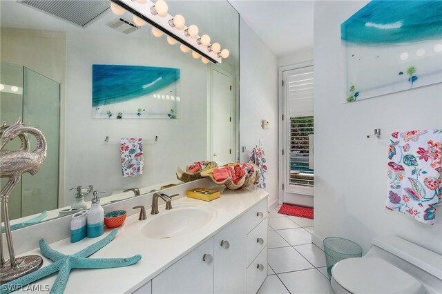 bathroom featuring tile floors, oversized vanity, and toilet