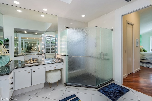 bathroom featuring a shower with shower door, wood-type flooring, and vanity