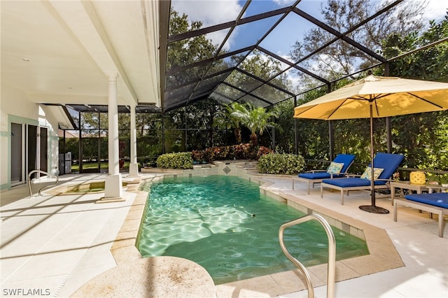 view of swimming pool with a patio area and a lanai