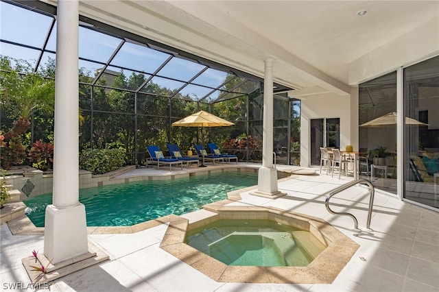 view of pool featuring a patio area, a lanai, and an in ground hot tub