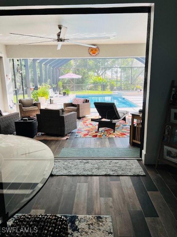 living room with ceiling fan and wood-type flooring