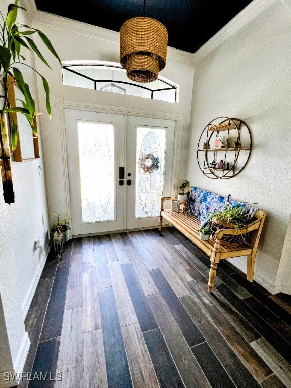 entryway with hardwood / wood-style floors, french doors, and ornamental molding