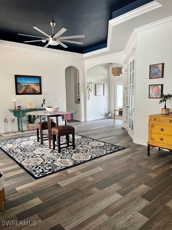 dining area featuring ceiling fan, a raised ceiling, french doors, hardwood / wood-style flooring, and ornamental molding