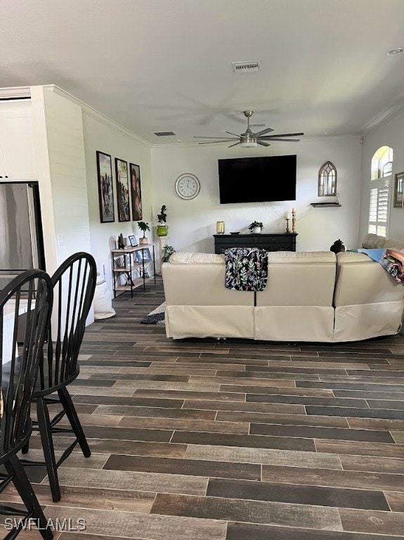 living room with ceiling fan, wood-type flooring, and crown molding