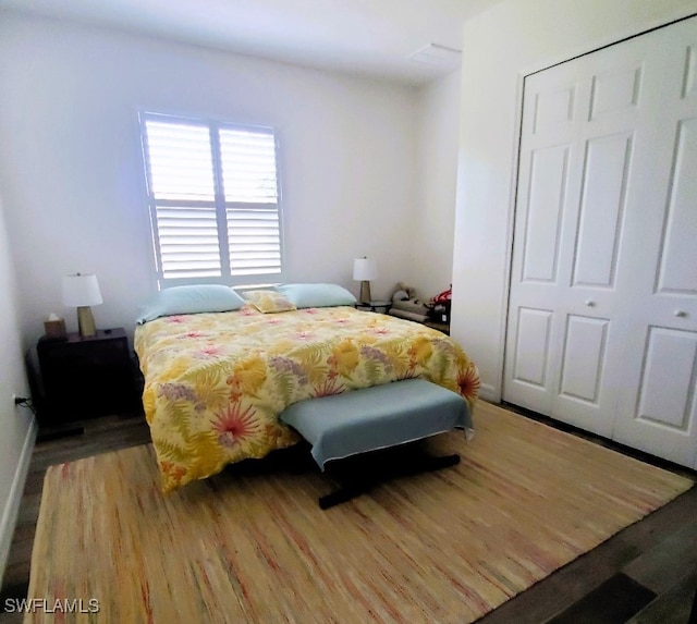 bedroom featuring hardwood / wood-style floors and a closet