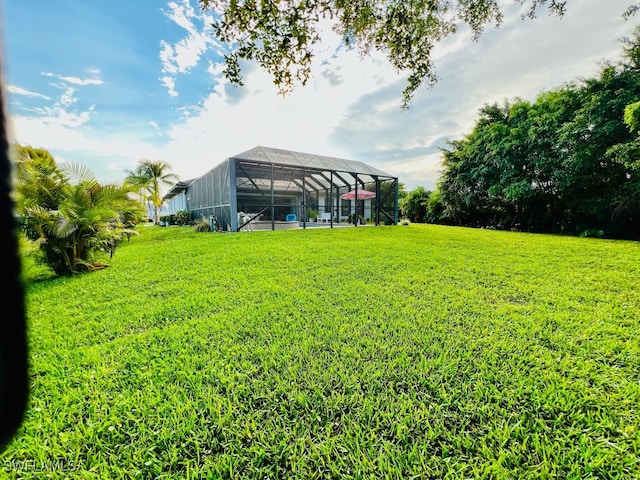 view of yard with glass enclosure and a swimming pool