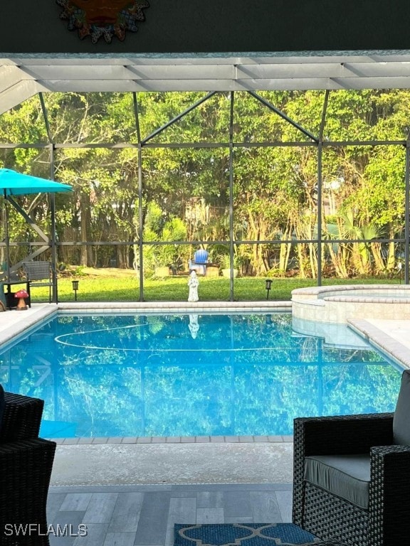 view of swimming pool with glass enclosure