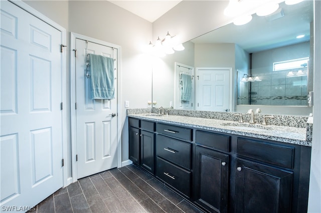 bathroom with vanity and a tile shower