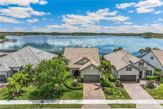 birds eye view of property with a water view