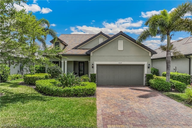 view of front of home with a garage and a front lawn