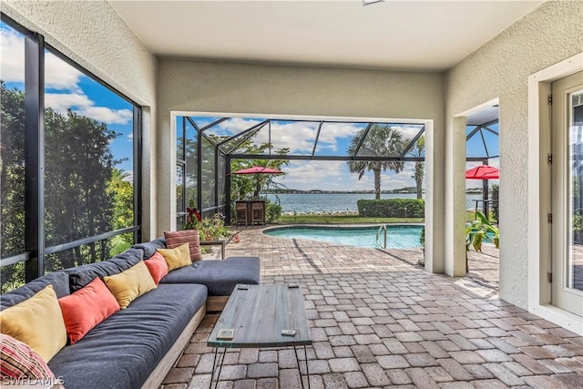 unfurnished sunroom featuring a water view