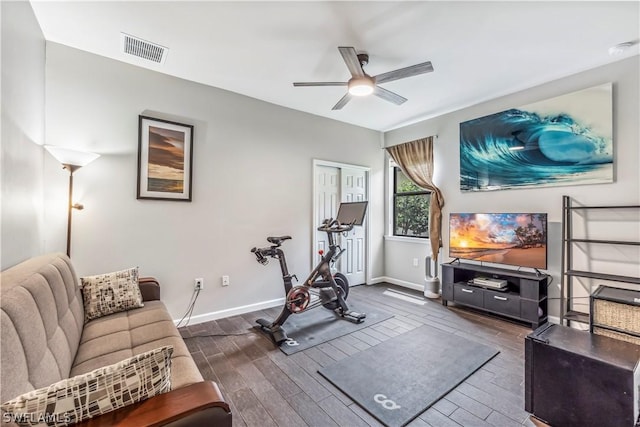 exercise area featuring ceiling fan and dark hardwood / wood-style flooring