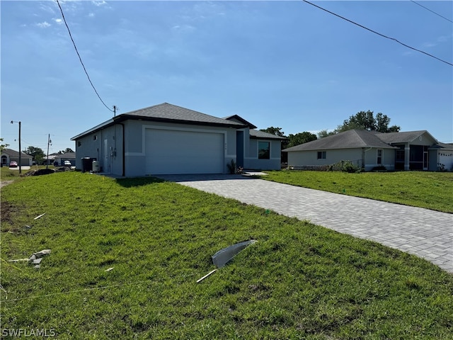 ranch-style home featuring a garage and a front lawn